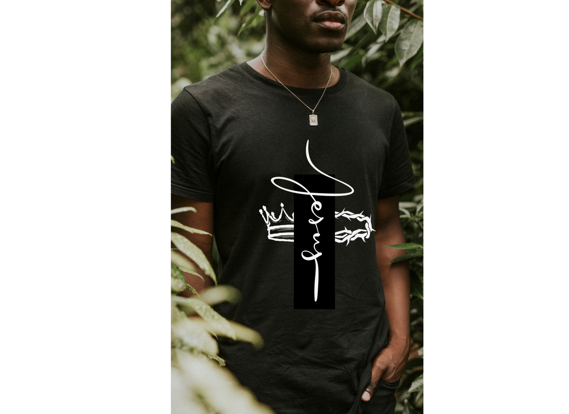 Person wearing a black t-shirt with white text and graphics against a natural background