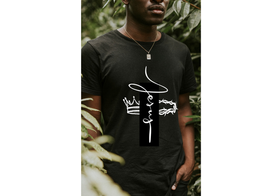 Person wearing a black t-shirt with white text and graphics against a natural background